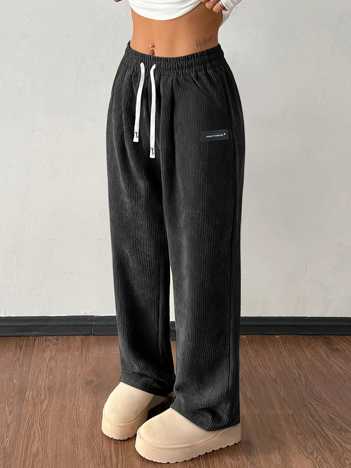 Black wide-leg corduroy pants with elastic high waist and drawstring