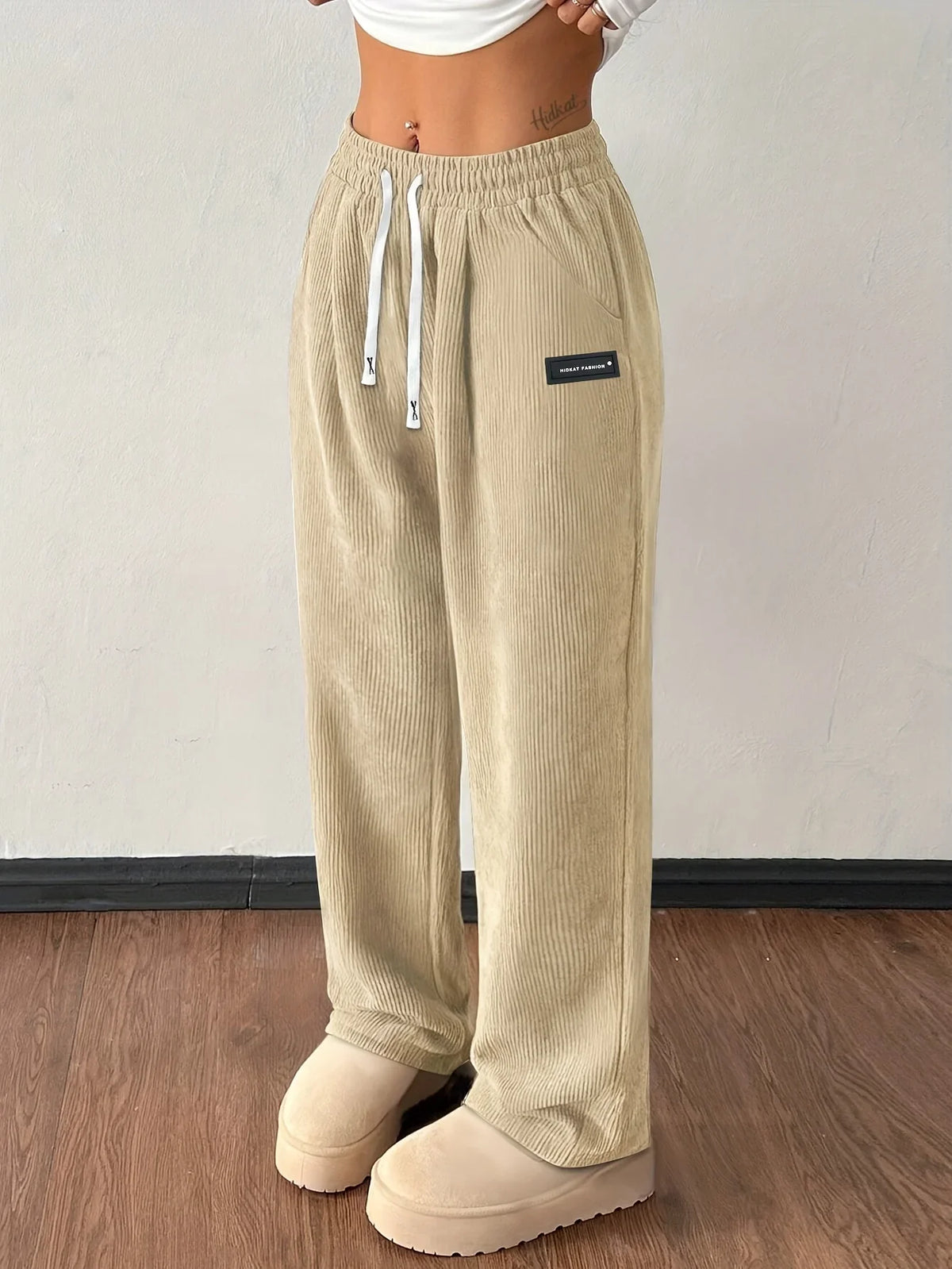 Beige wide-leg corduroy pants with elastic high waist and drawstring