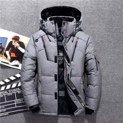 Gray duck down parka with a water-resistant nylon shell, adjustable hood, and neoprene storm cuffs on a textured background.