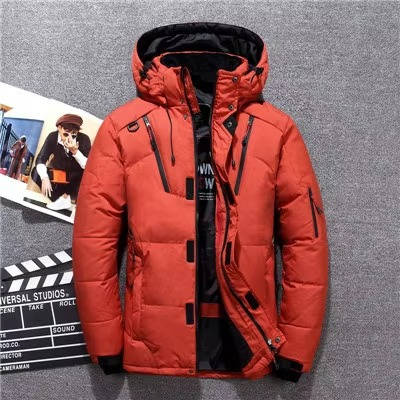 Burnt orange duck down parka with a water-resistant nylon shell, adjustable hood, and black neoprene storm cuffs.