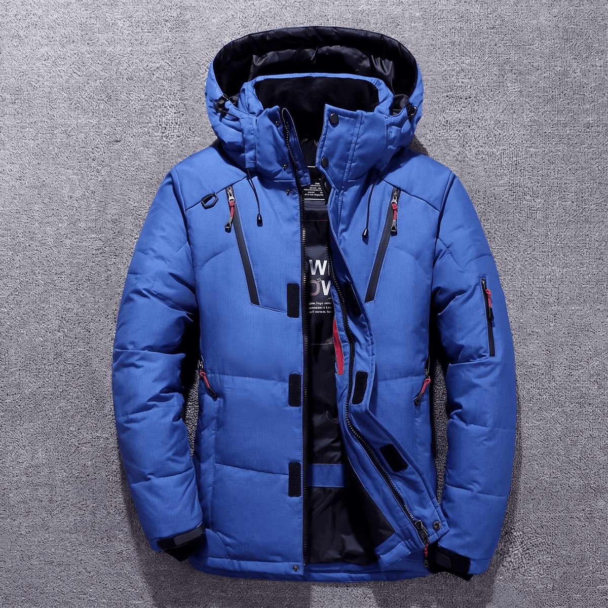 Blue duck down parka with a water-resistant nylon shell, adjustable hood, and neoprene storm cuffs on a grey background.