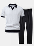 Men's white textured knit polo shirt with contrast black collar and sleeve trim paired with black straight-leg trousers displayed as a coordinated smart casual outfit.