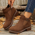 Brown suede Chelsea ankle boots with buckle straps, elastic side panels, and a rugged lug sole block heel.
