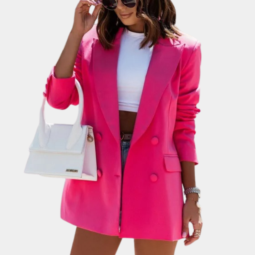 Hot pink double-breasted blazer with structured shoulders and a tailored, mid-length fit worn over a white crop top.