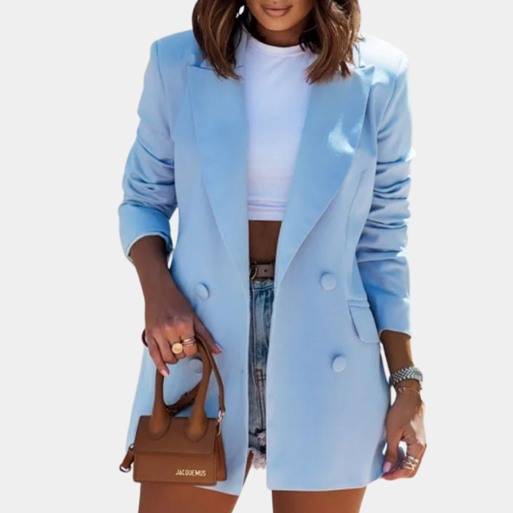 Light blue double-breasted blazer with structured shoulders and a tailored mid-length fit worn over a white crop top.