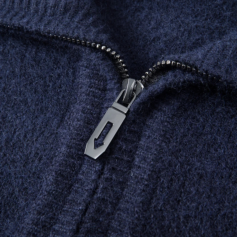 Navy blue mid-weight knit quarter zip sweater featuring a textured yarn finish and a metallic zipper pull.