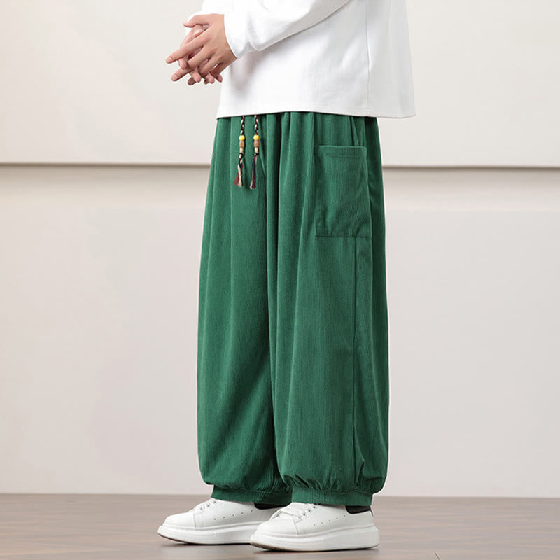 Green fine-wale corduroy harem pants with side patch pockets, beaded drawstring waist, and cuffed ankles.