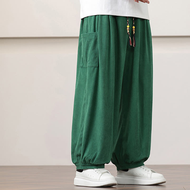 Green fine-wale corduroy harem pants with side patch pockets, beaded drawstring waist, and cuffed ankles.