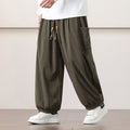 Olive green fine-wale corduroy harem pants with side patch pockets, beaded drawstring waist, and cuffed ankles.