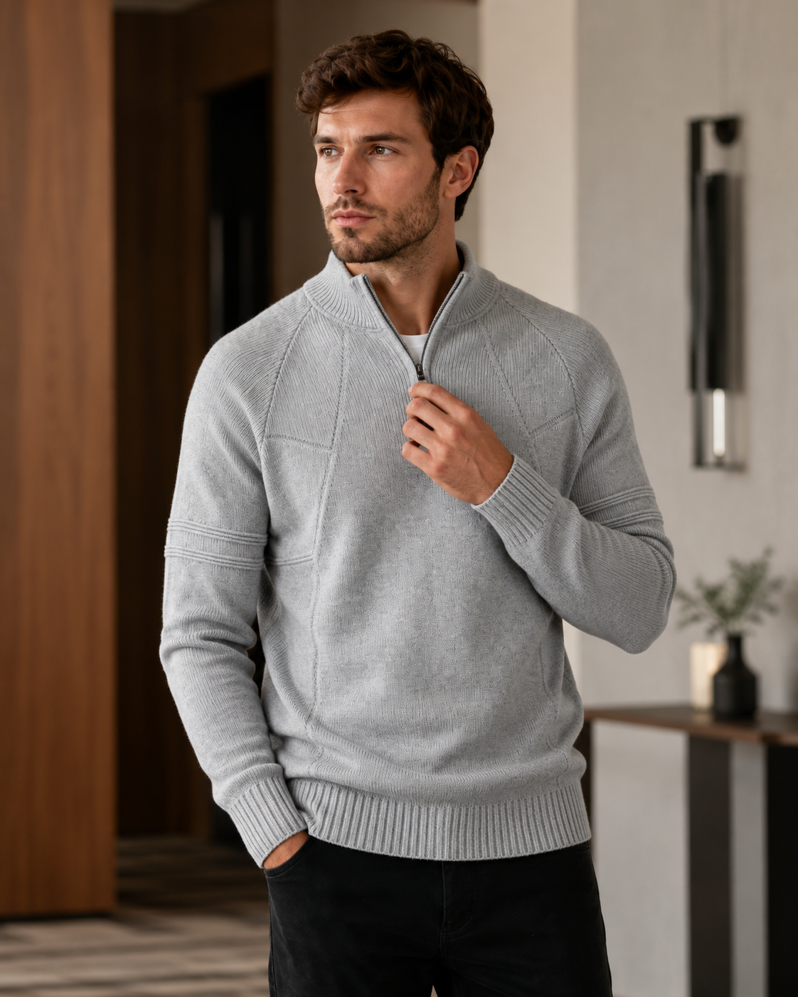 Light gray quarter-zip knit sweater worn by male model indoors