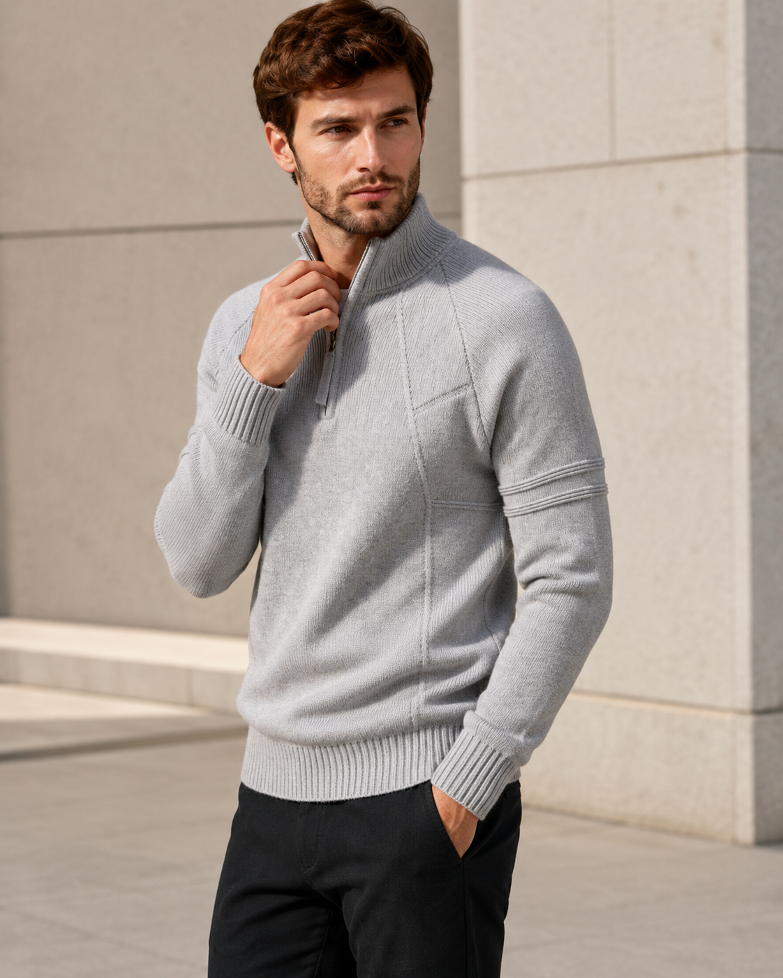 Light gray fitted quarter-zip sweater worn by male model adjusting the collar