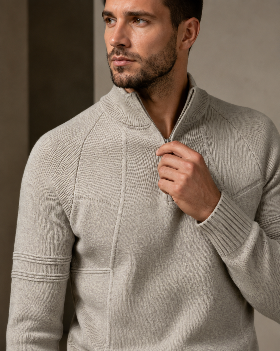 Close-up of beige fitted quarter-zip sweater worn by male model