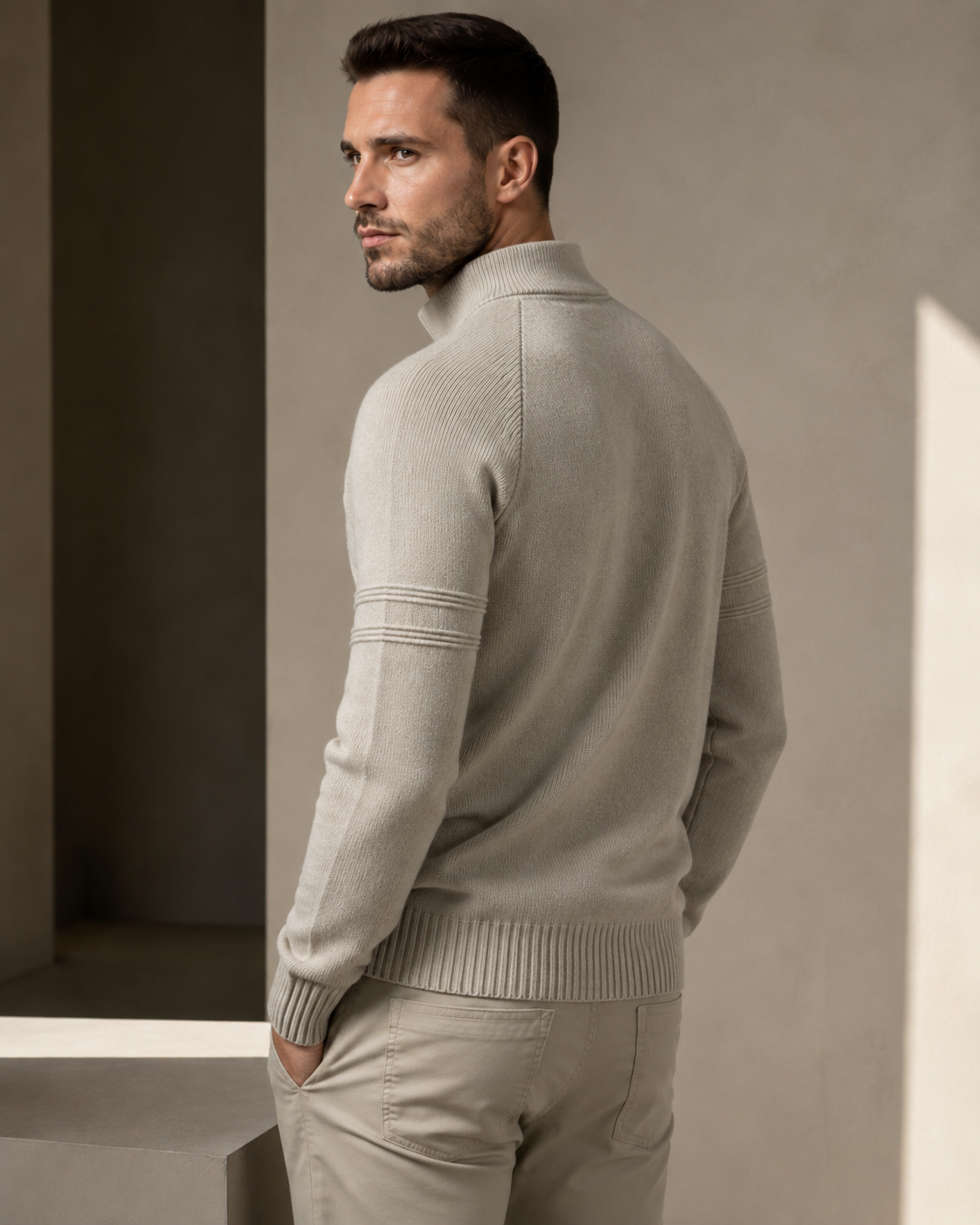 Beige fitted quarter-zip sweater worn by male model, back view