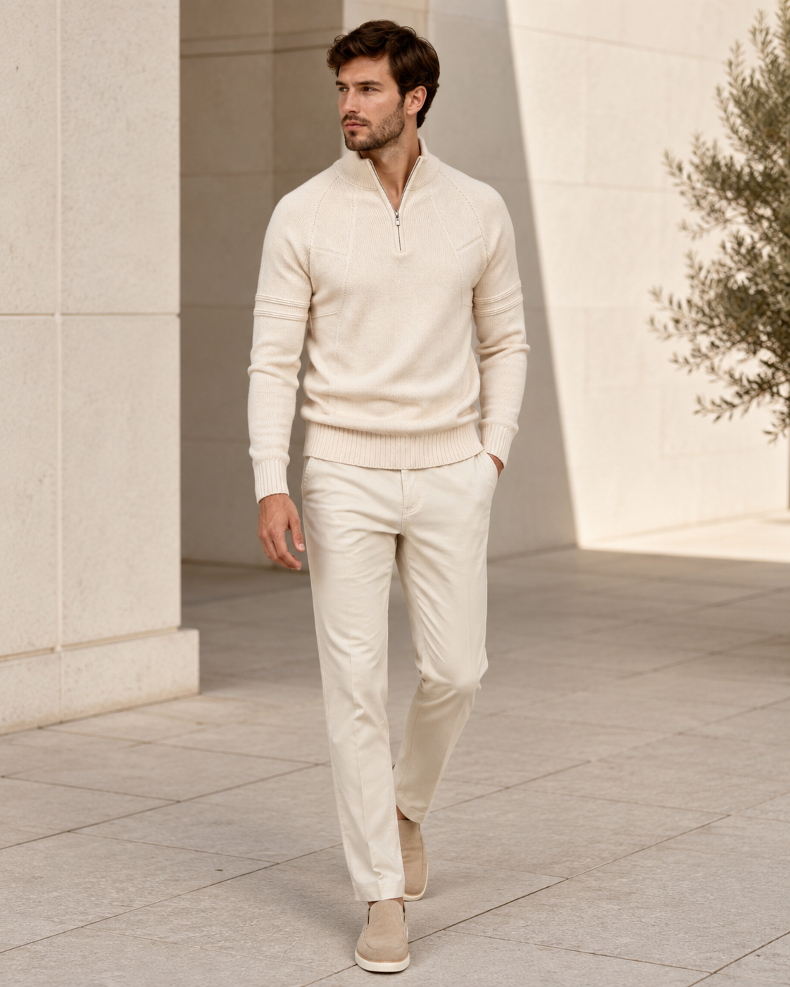 Cream fitted quarter-zip sweater worn by male model standing in neutral setting