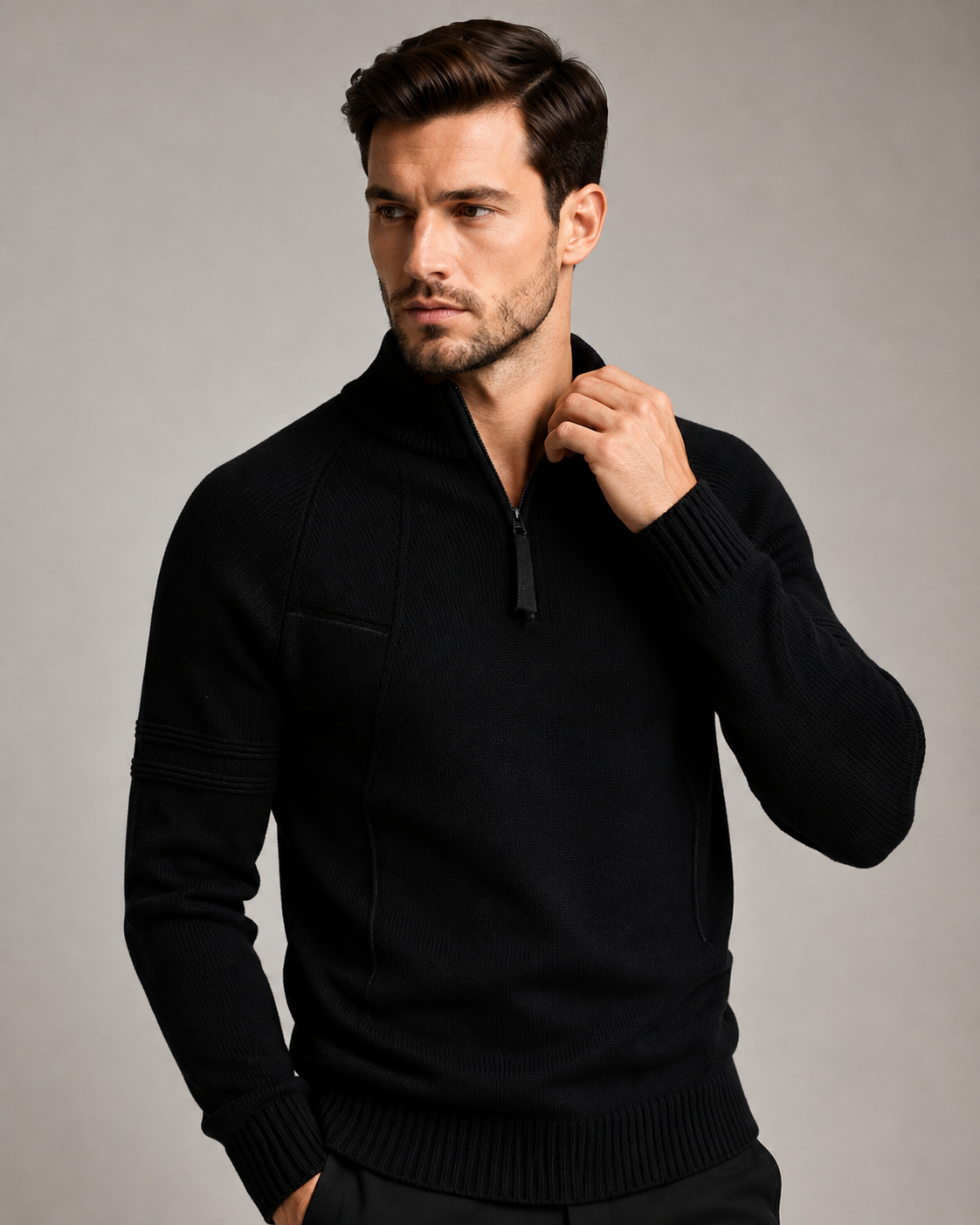 Black quarter-zip knit sweater worn by male model, close-up view