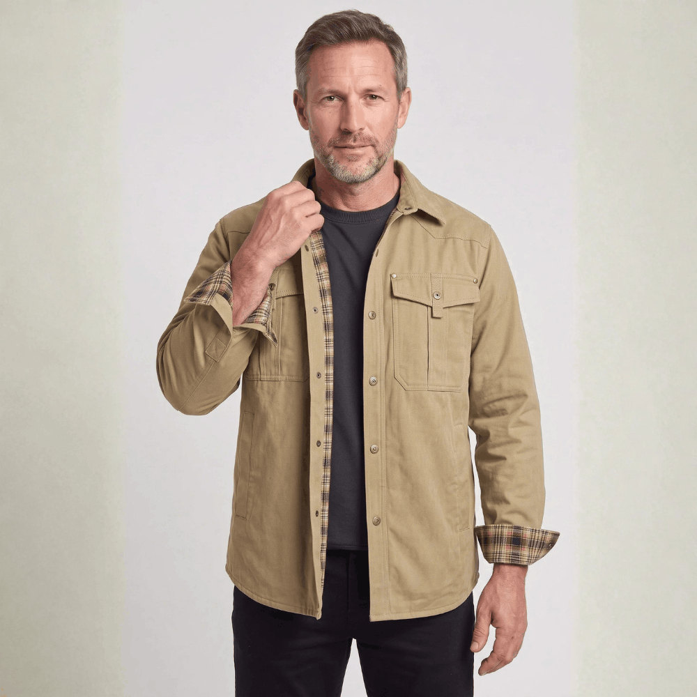 Front view of a model wearing a khaki khaki flannel-lined barn jacket with metal snap front placket.