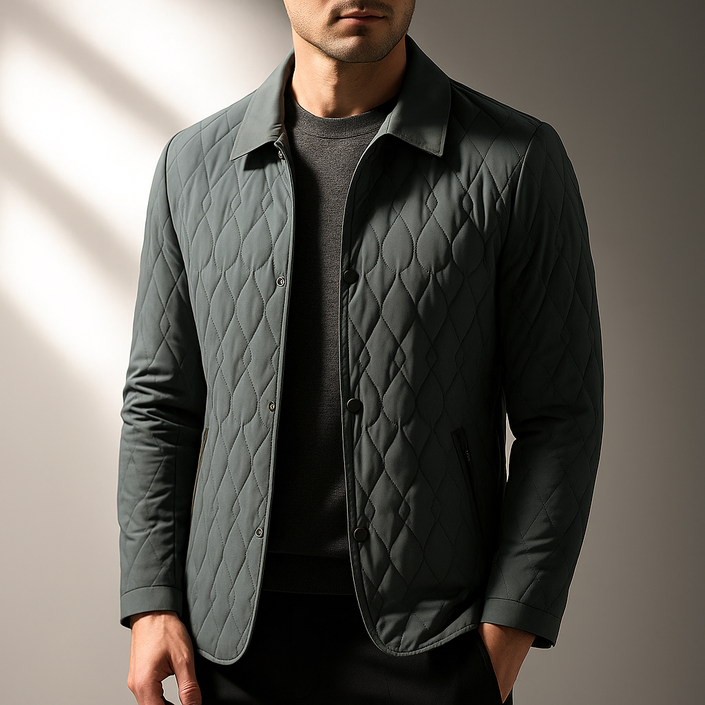 Sage green diamond-stitch quilted jacket with a turn-down collar and button-front closure worn over a dark sweater.