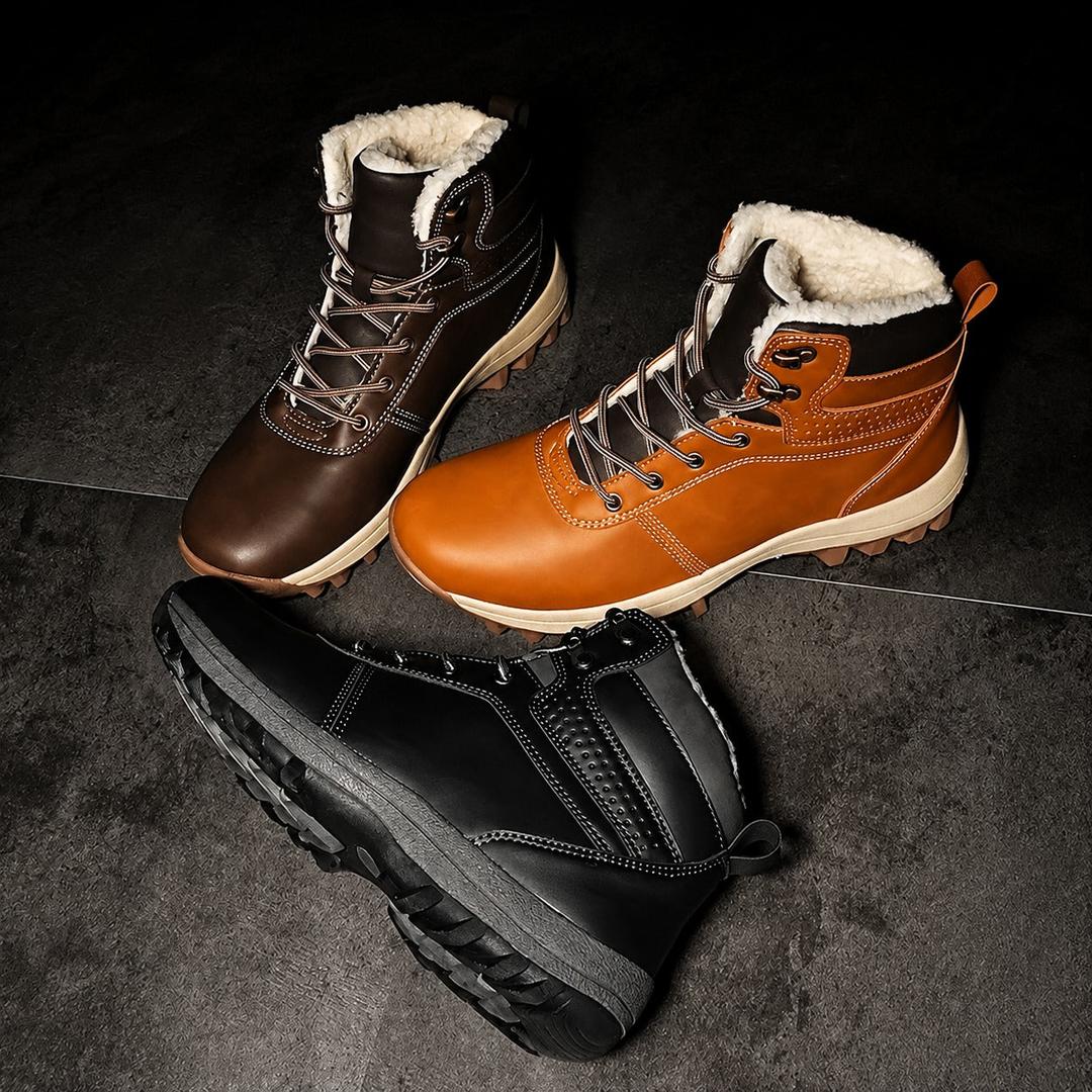 Men's fleece-lined ankle boots in black, brown, and tan leather with lace-up fronts, padded collars, and deep lugged soles.
