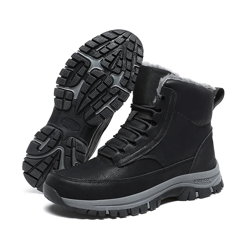 Pair of black lace-up ankle boots for men tilted to show the deep lug sole tread pattern