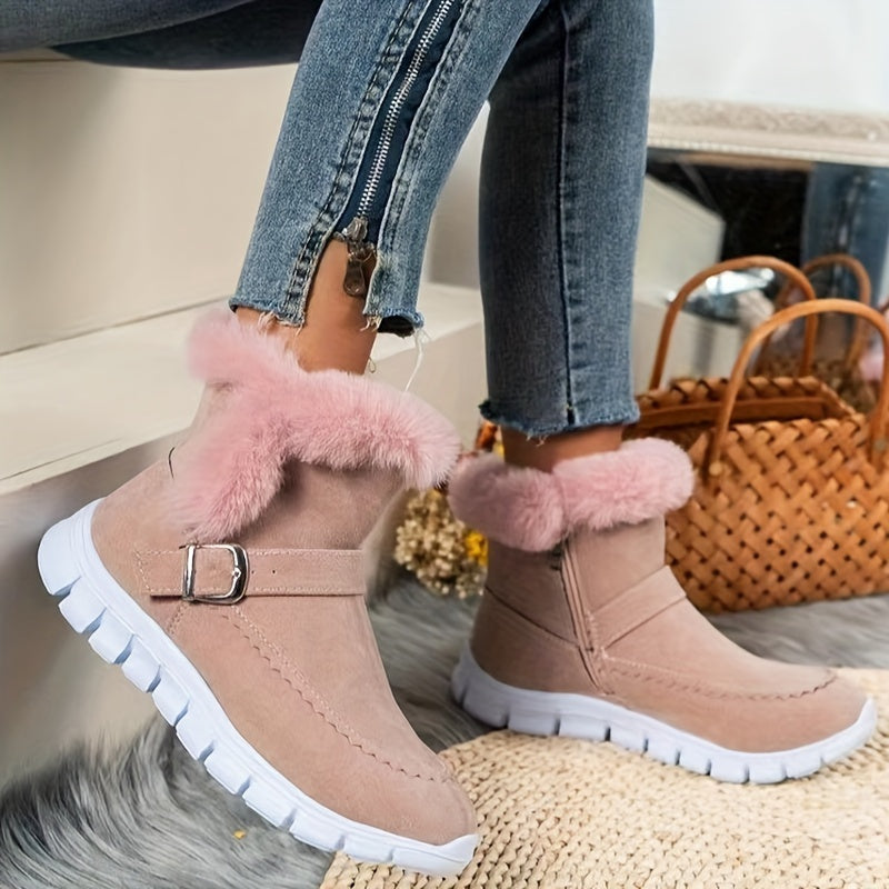 Pink faux fur trim ankle boots for women with buckle strap and treaded white outsole, worn with jeans