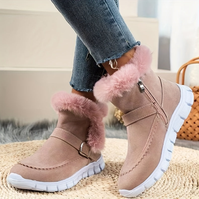 Pink fleece-lined ankle boots for women showing the fur-look collar, side zip and buckle strap