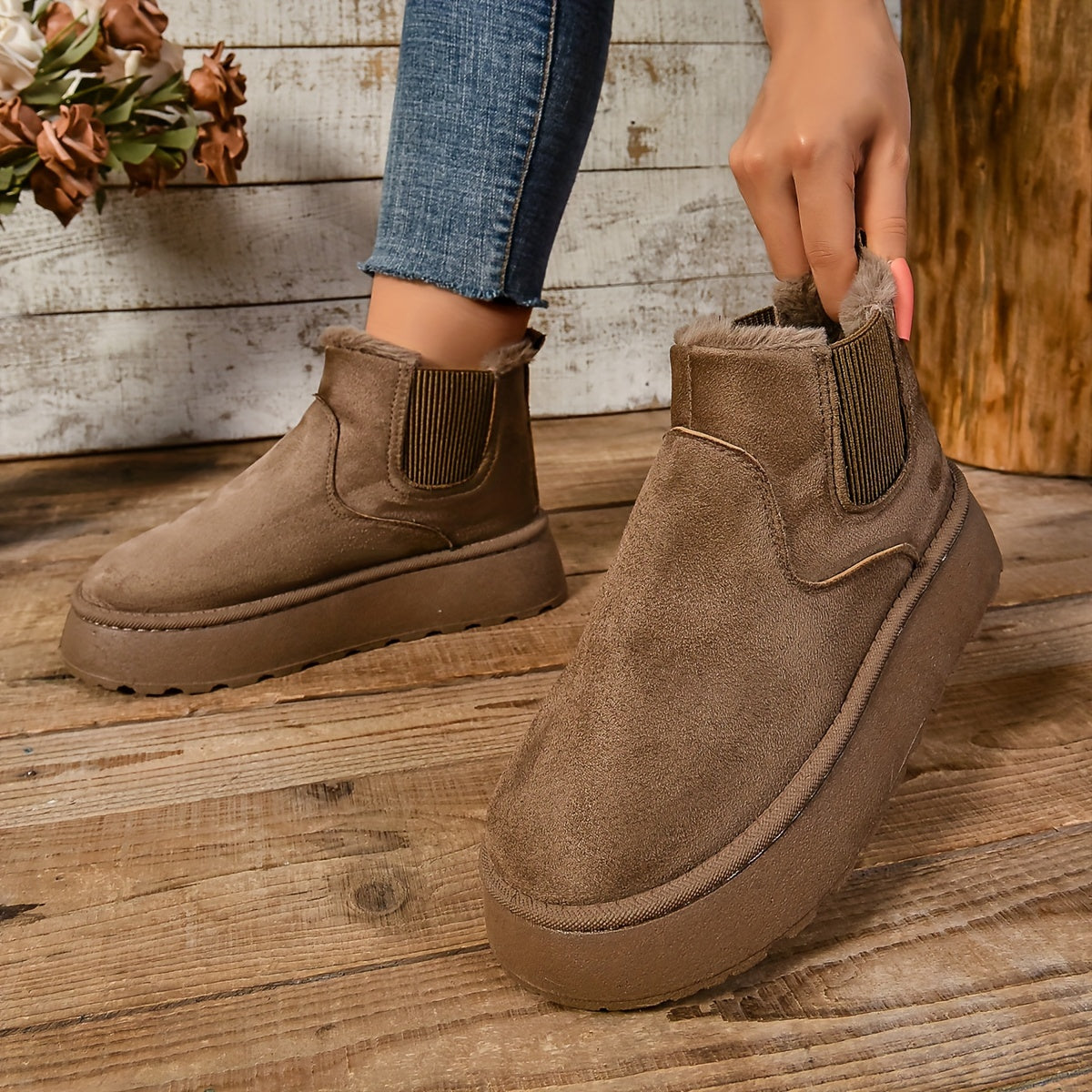 Brown suede-look platform Chelsea boot held open to show the fleece lining and elastic gore panel