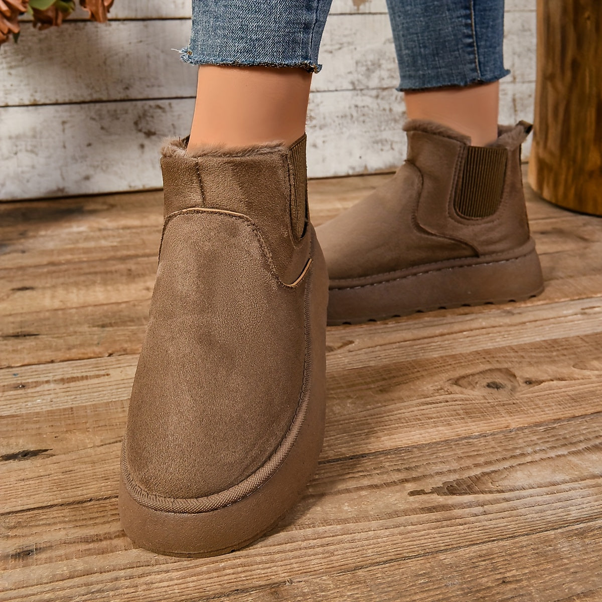 Close-up of a brown suede-look platform Chelsea boot showing the fleece cuff and chunky platform sole