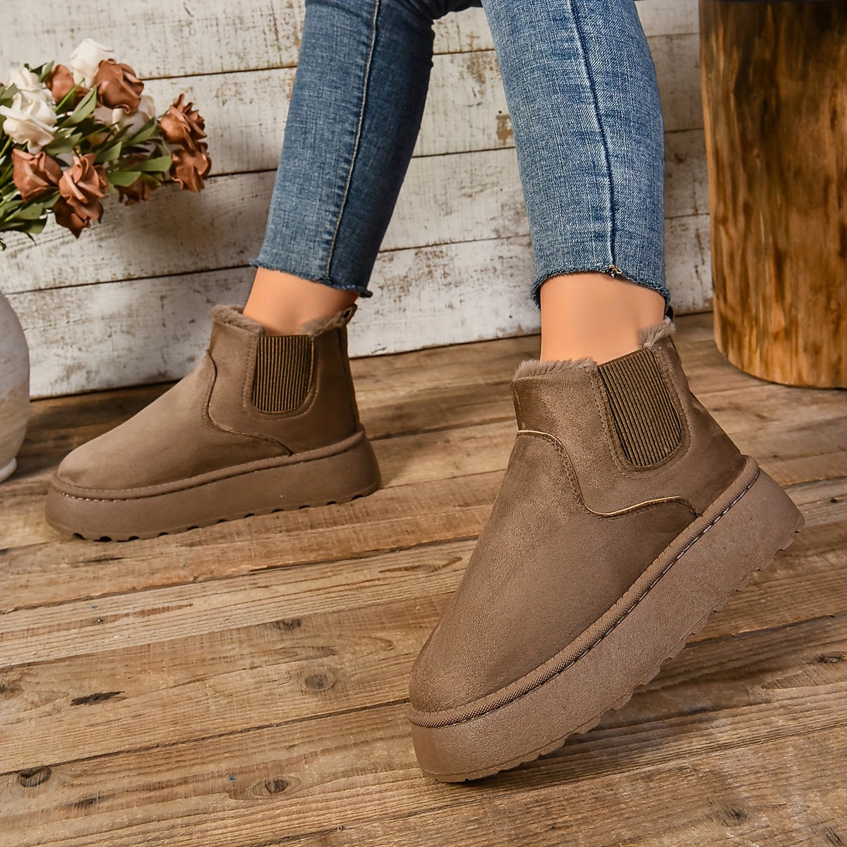 Close-up of a brown suede-look platform Chelsea boot showing the fleece cuff and chunky platform sole