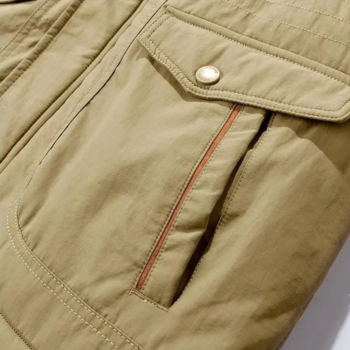 Khaki utility jacket featuring a cargo flap pocket with a contrast orange zip detail and reinforced topstitching.