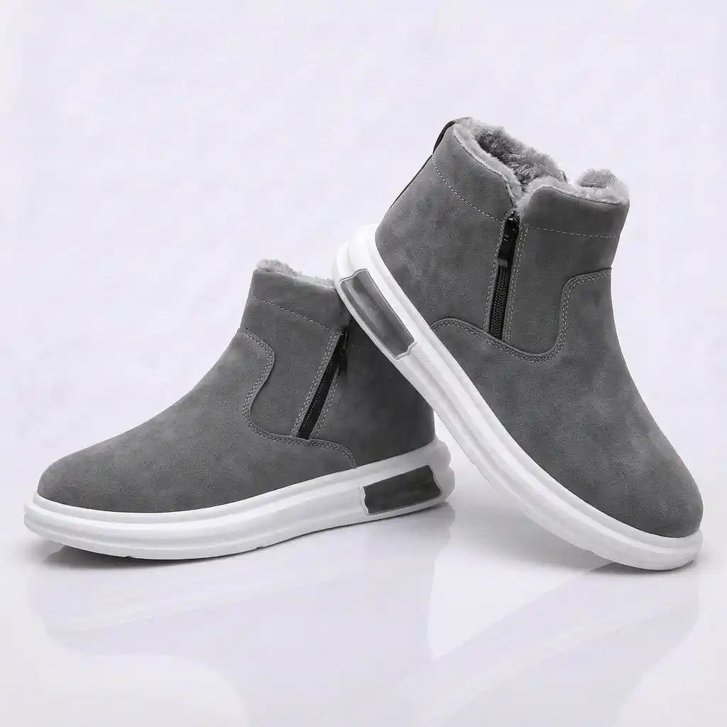 Pair of gray fleece-lined ankle boots with side zip and white sole, on a white background