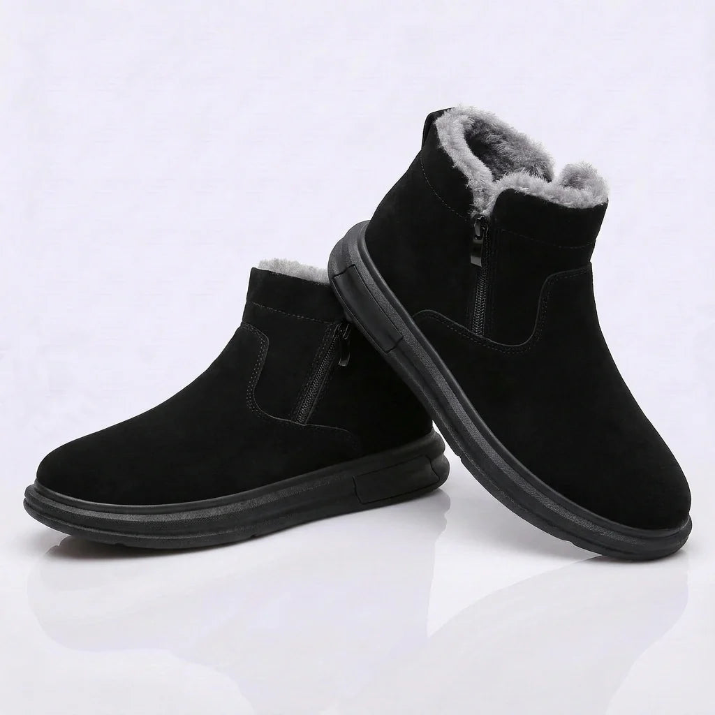 Pair of black fleece-lined ankle boots with side zip entry and fleece collar, on a white background