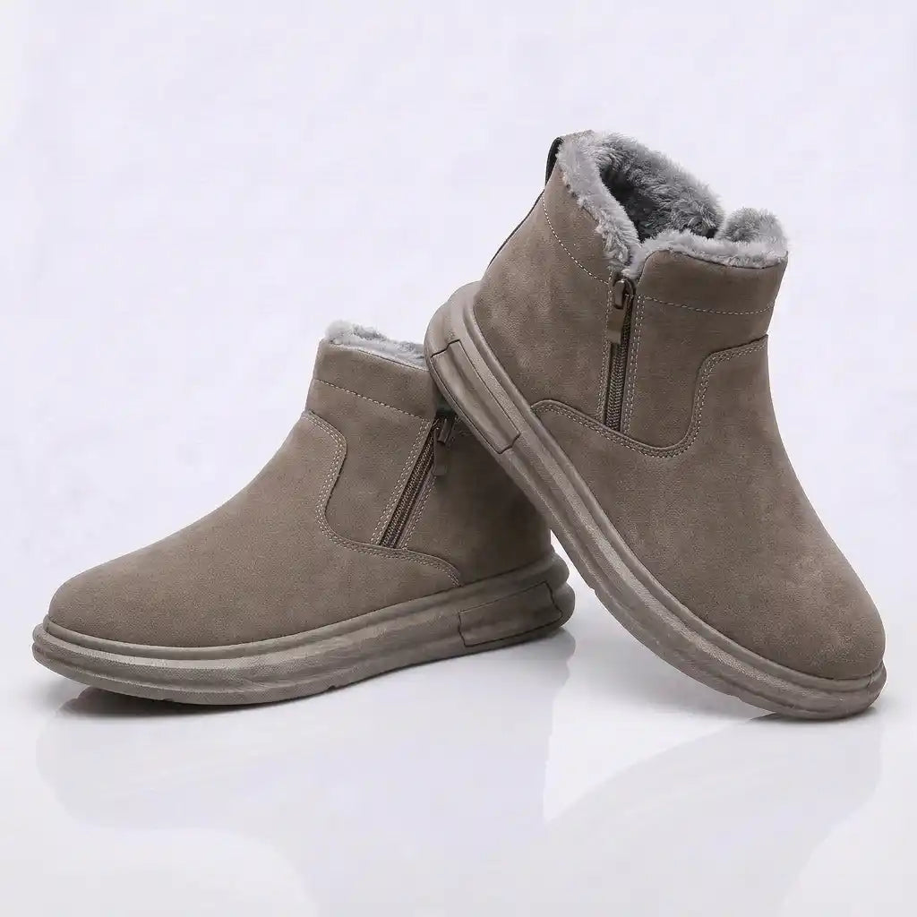 Pair of taupe fleece-lined ankle boots with side zip entry and fleece collar, on a white background