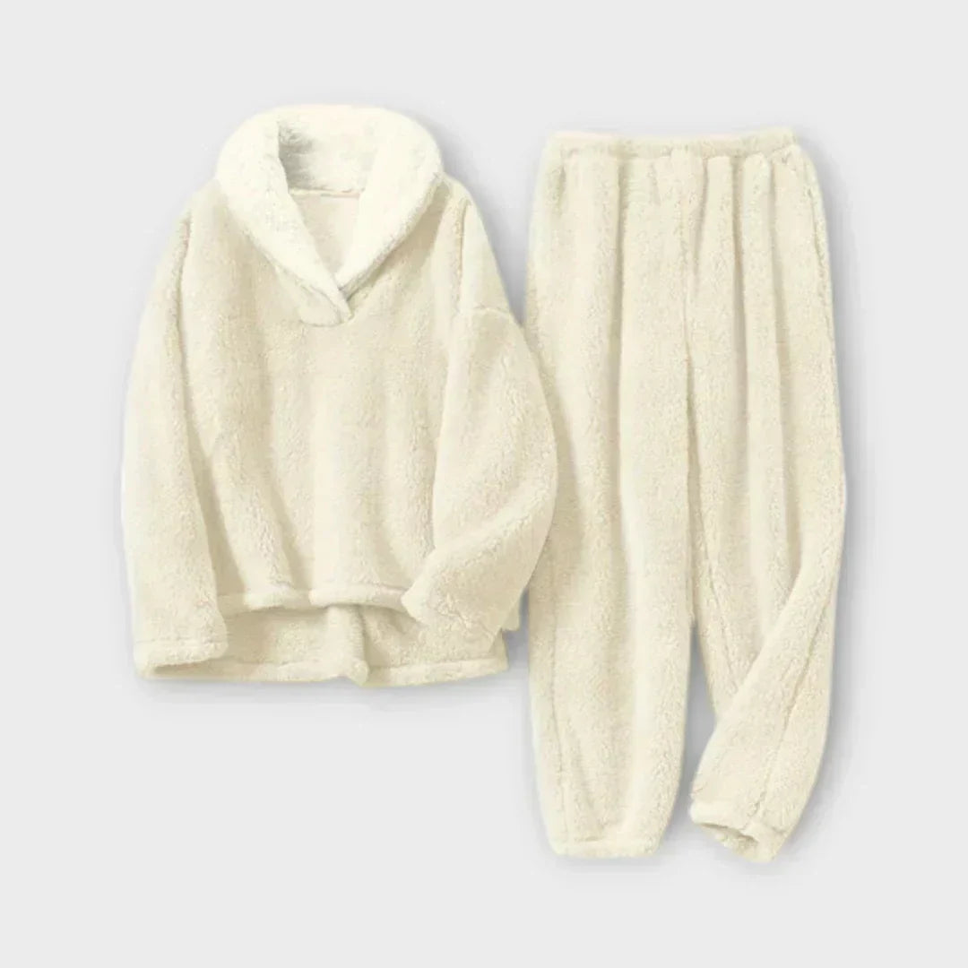 Product flat-lay view of the plush fleece lounge set in cream off-white featuring a matching sherpa lapel collar pullover and elastic-waist fleece joggers.