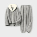 Product flat-lay view of a light gray fleece lounge set featuring a long-sleeve plush pullover with a off-white contrast sherpa lapel collar and matching elastic-waist fleece joggers.