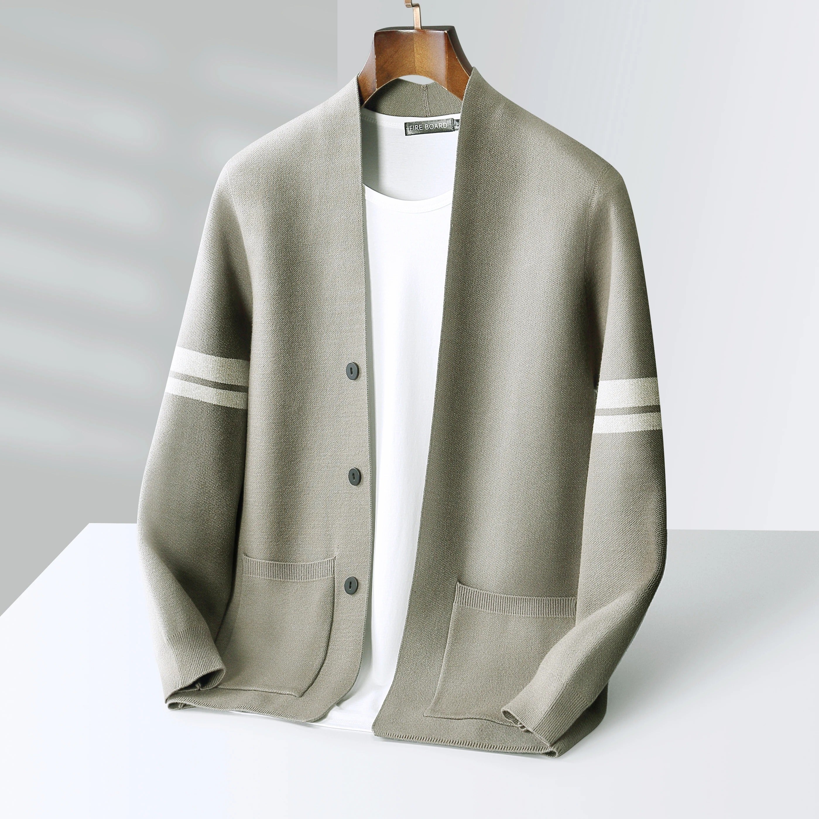 Taupe wool-blend V-neck cardigan with sleeve stripes, button front, and front pockets, layered over a white shirt.