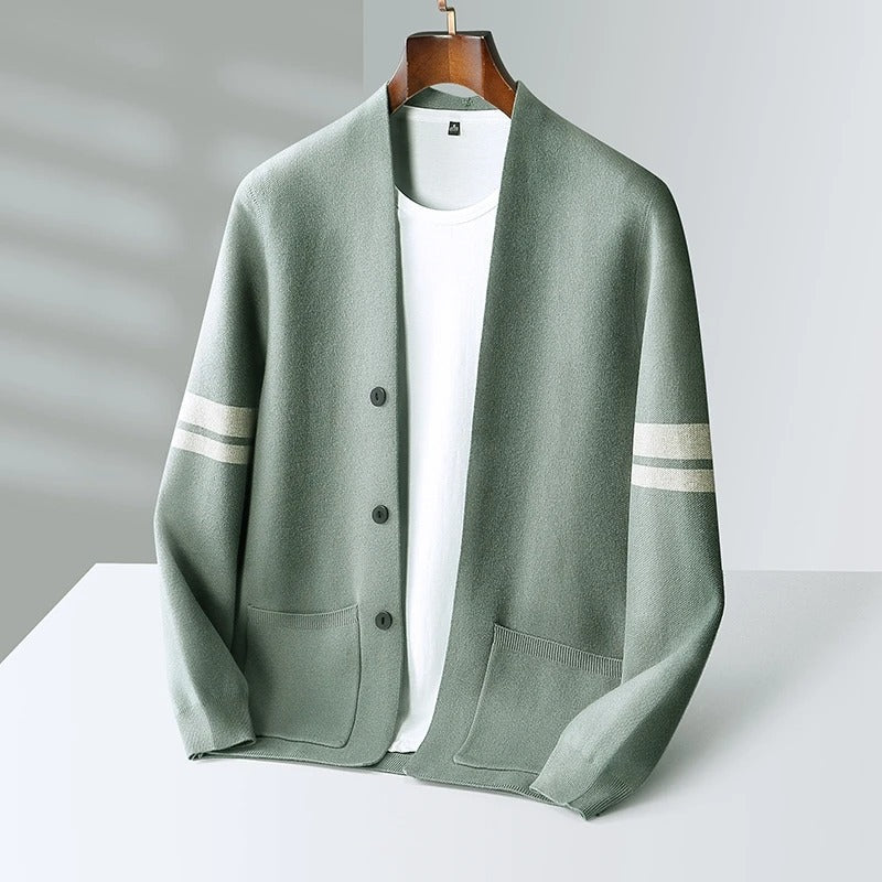 Sage green wool-blend V-neck cardigan with button front, patch pockets, and contrasting white sleeve stripes.