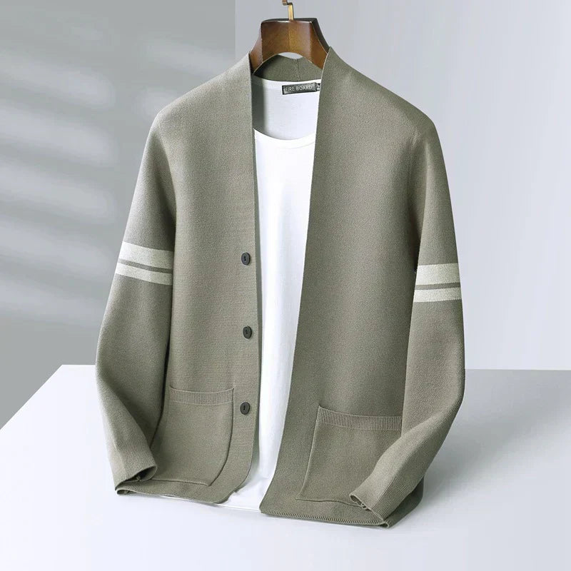 Sage green wool-blend V-neck cardigan with sleeve stripes, button front, and patch pockets on a white background.