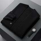 Black wool-blend V-neck cardigan with a tailored button-front, folded neatly beside a classic leather-strap watch.
