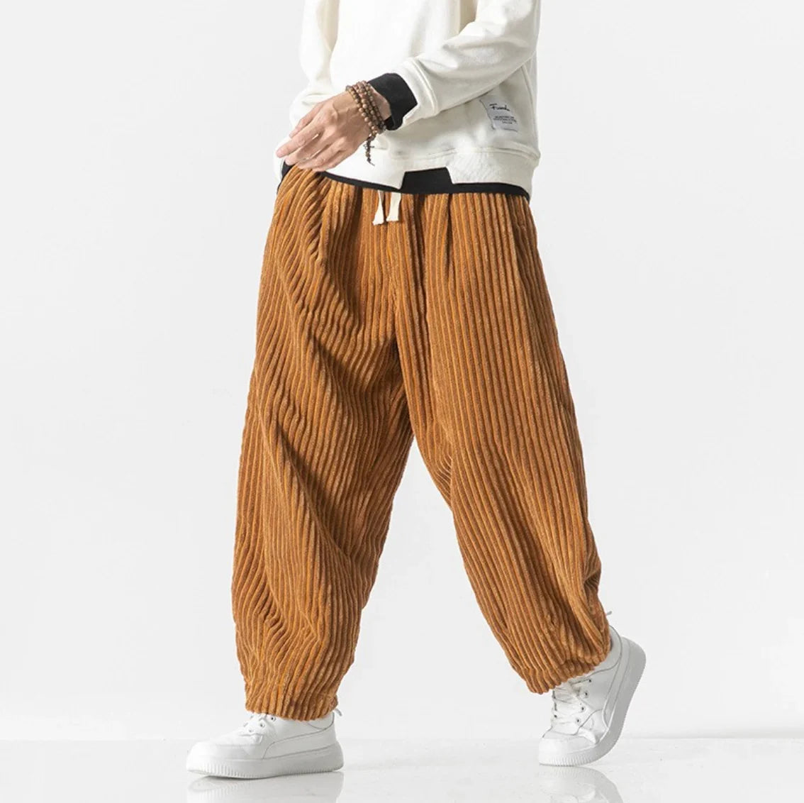 Orange gathered-cuff corduroy pants with wide-leg fit and drawstring waist