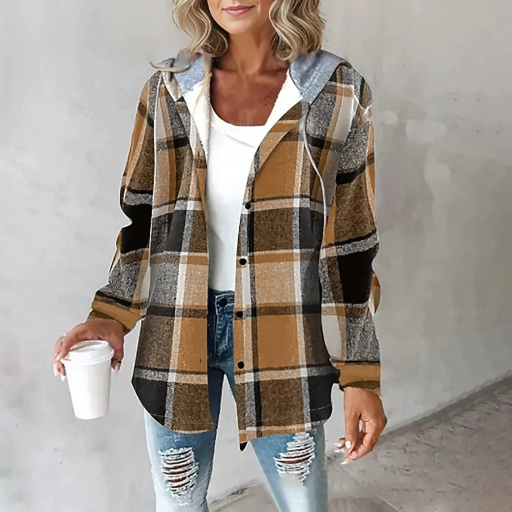 Brown and black plaid flannel shacket with a grey drawstring hood and soft sherpa lining in a relaxed, button-up fit.