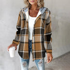 Brown and black plaid flannel shacket with a grey drawstring hood and soft sherpa lining in a relaxed, button-up fit.