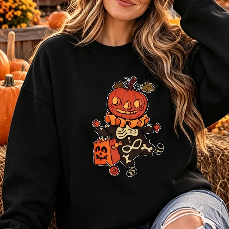 Model wearing the Halloween cartoon pumpkin skeleton graphic crewneck sweatshirt in classic black, posed outdoors against autumn pumpkins.