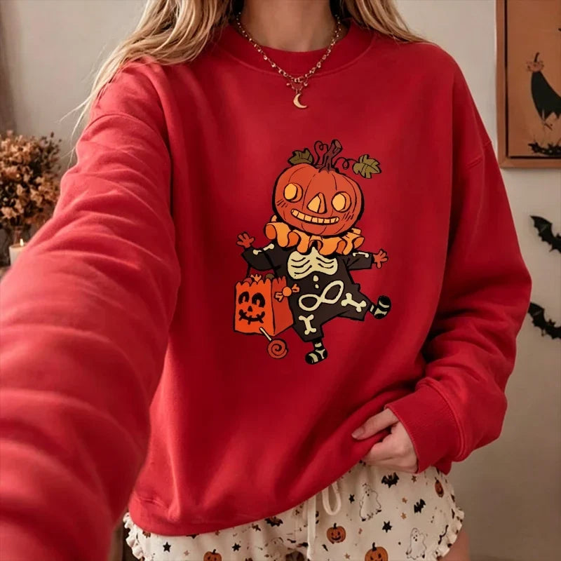 Model wearing the Halloween cartoon pumpkin skeleton graphic relaxed pullover sweatshirt in bright red.