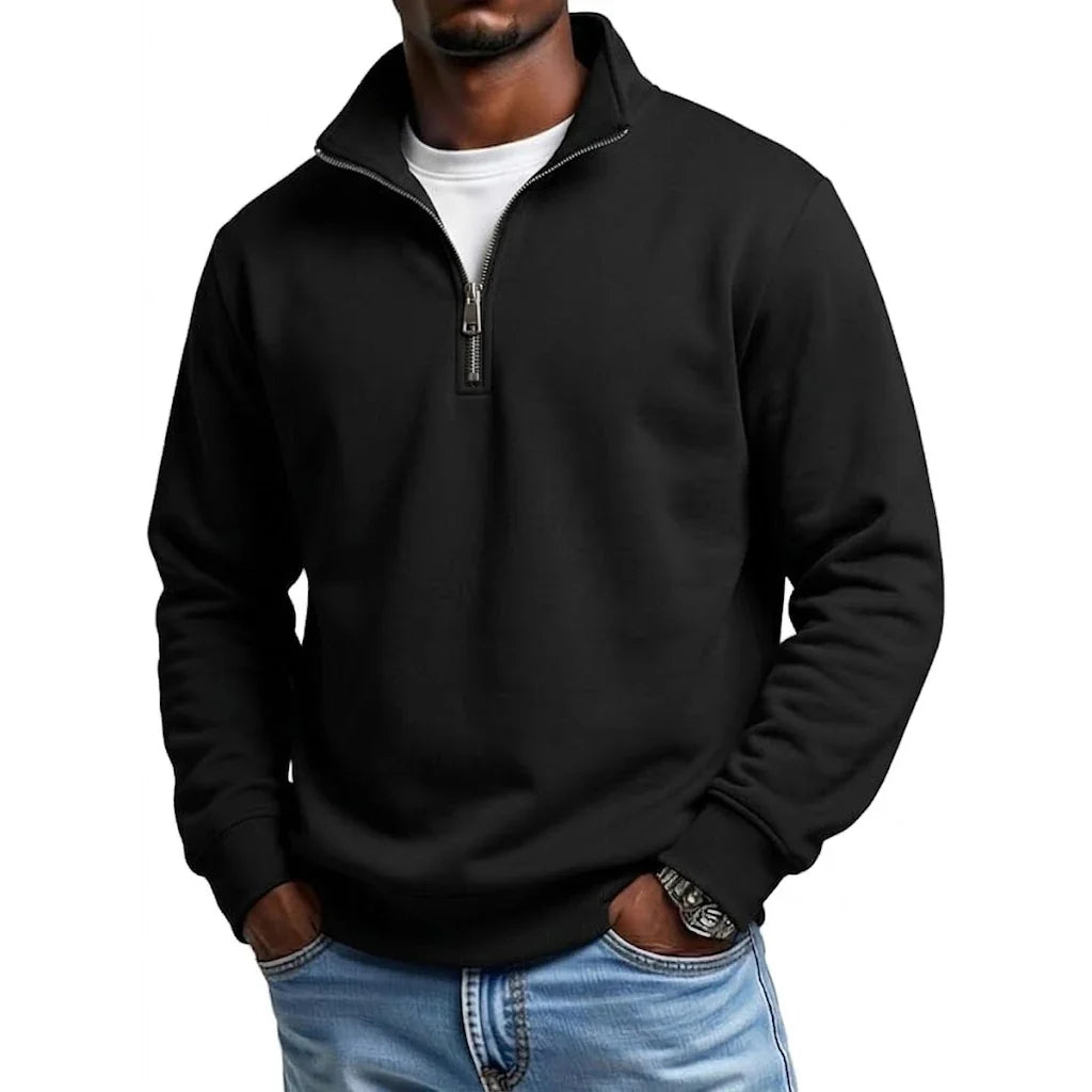 Black quarter-zip fleece sweatshirt featuring a stand collar and long sleeves, styled with blue jeans.