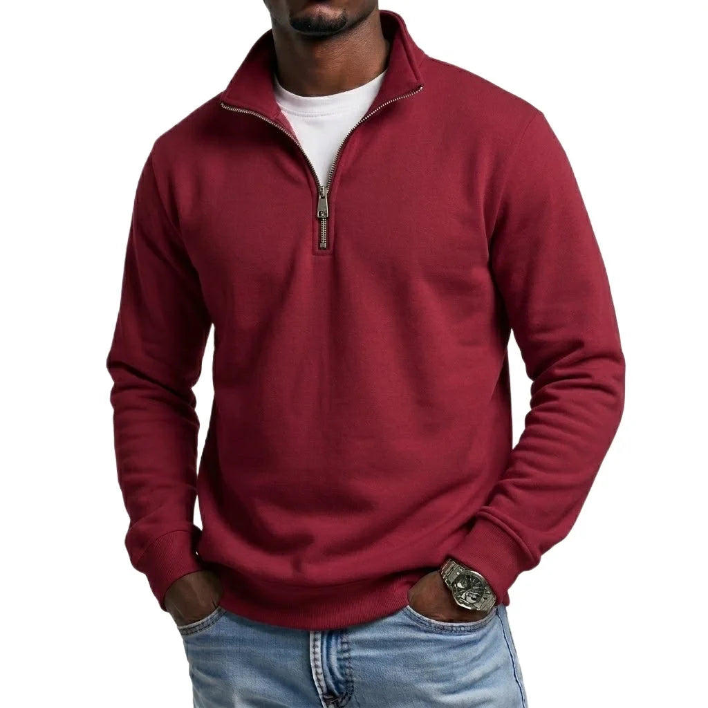Burgundy quarter-zip fleece sweatshirt featuring a stand collar and long sleeves, styled with blue jeans.