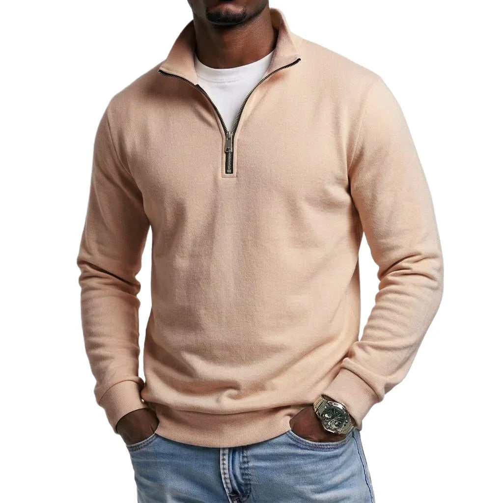 Khaki quarter-zip fleece sweatshirt with a stand collar and long sleeves, paired with blue jeans for a smart casual look.