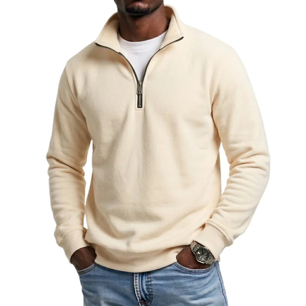 Beige quarter-zip fleece sweatshirt featuring a stand collar and long sleeves, styled with blue jeans.