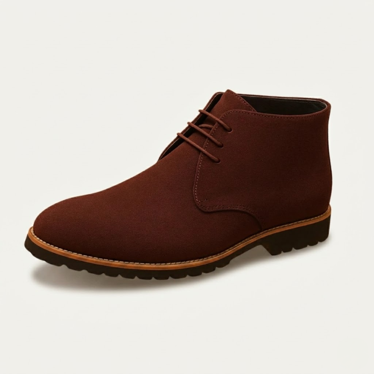 Brown suede chukka boots featuring a three-eyelet lace-up design, plain toe, and a durable lug tread outsole with stitched welt.