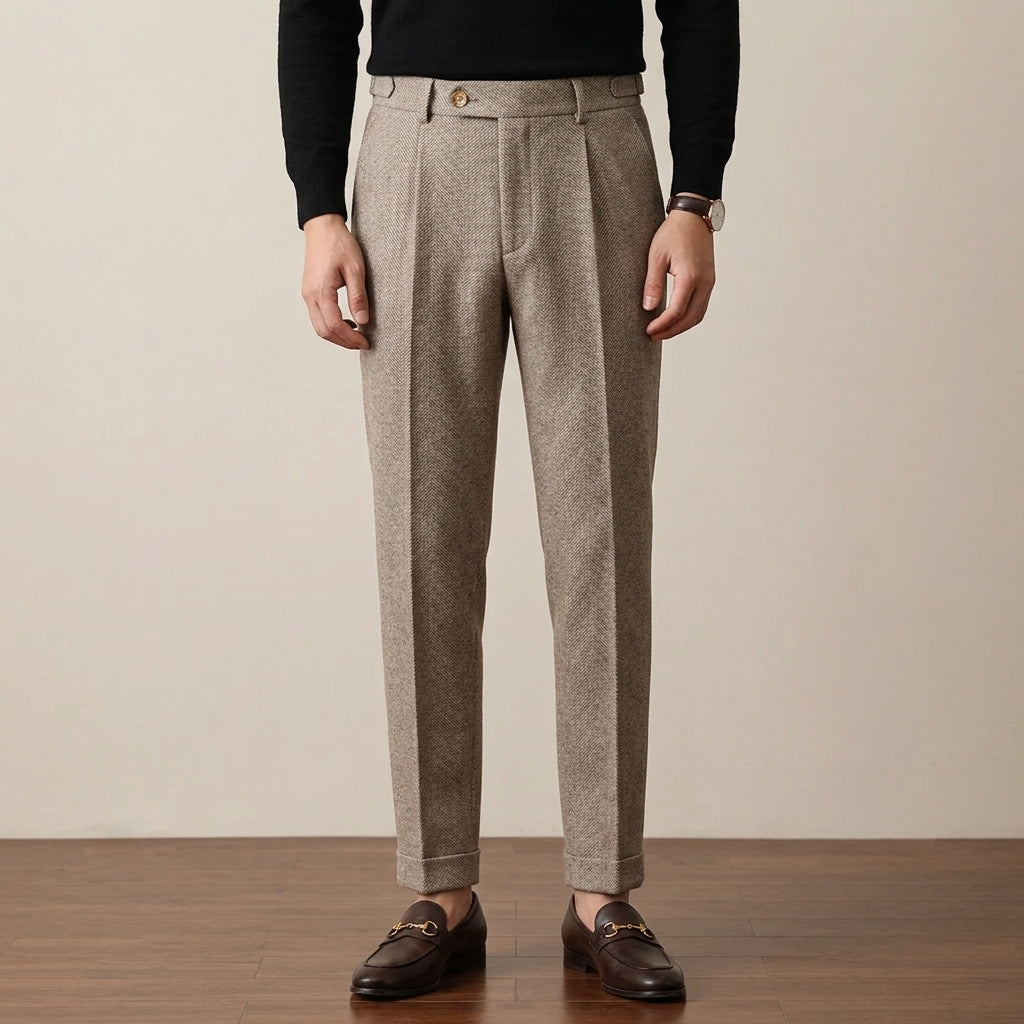 Tailored beige herringbone wool trousers with a clean fit, cuffed hems, and a structured button-fly waist.