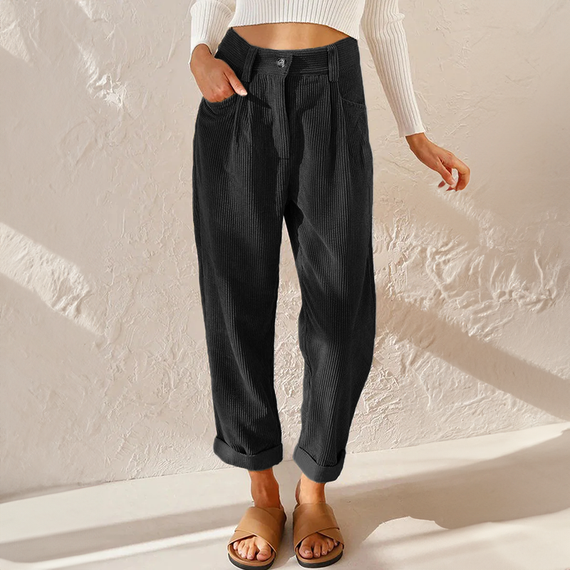 Black high-waisted corduroy pants with front pleats, a relaxed tapered leg, and adjustable turn-up cuffs.